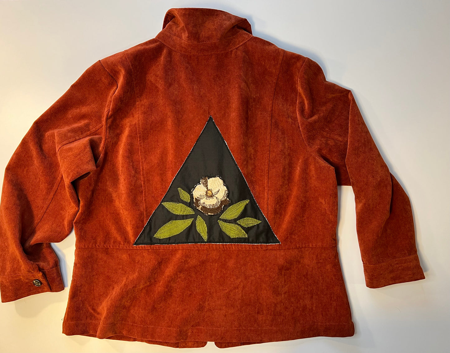 Burnt red jacket with floral patch