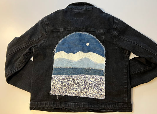 Black denim jacket with blue denim patch
