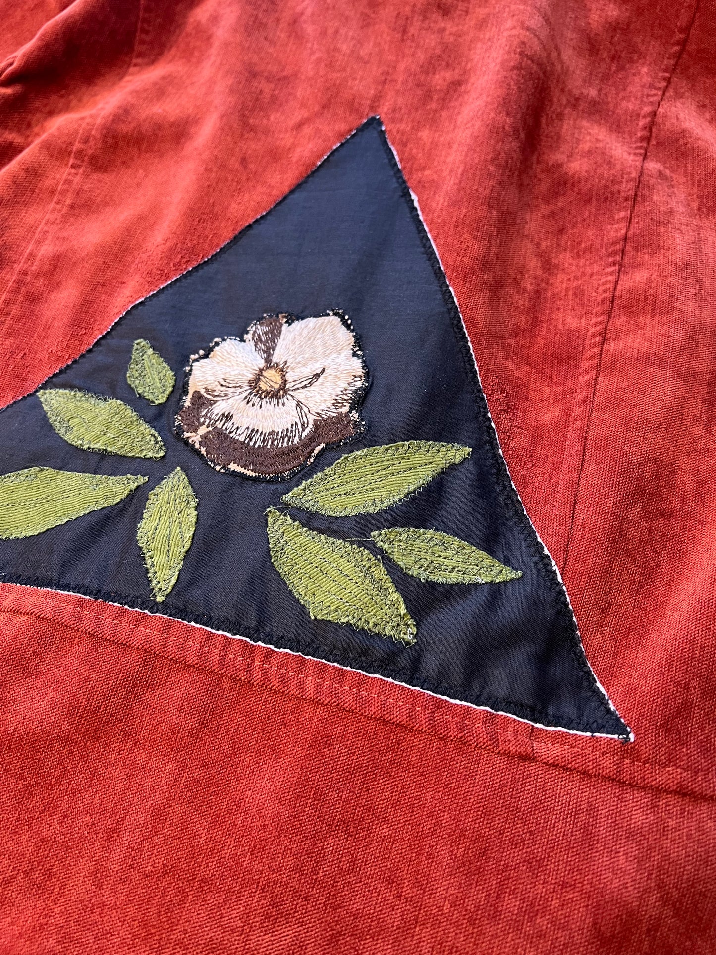 Burnt red jacket with floral patch