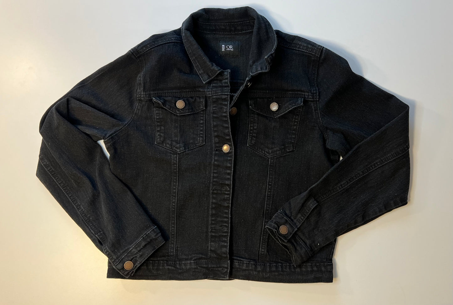 Black denim jacket with blue denim patch