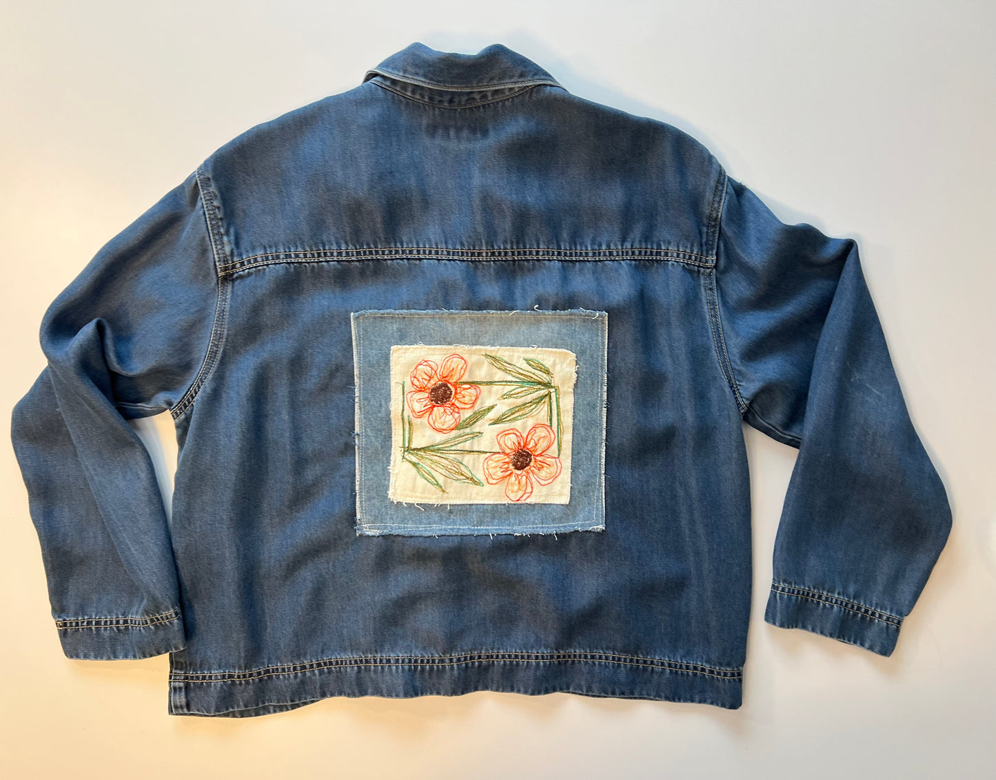 Soft light weight denim with embroidered floral patch