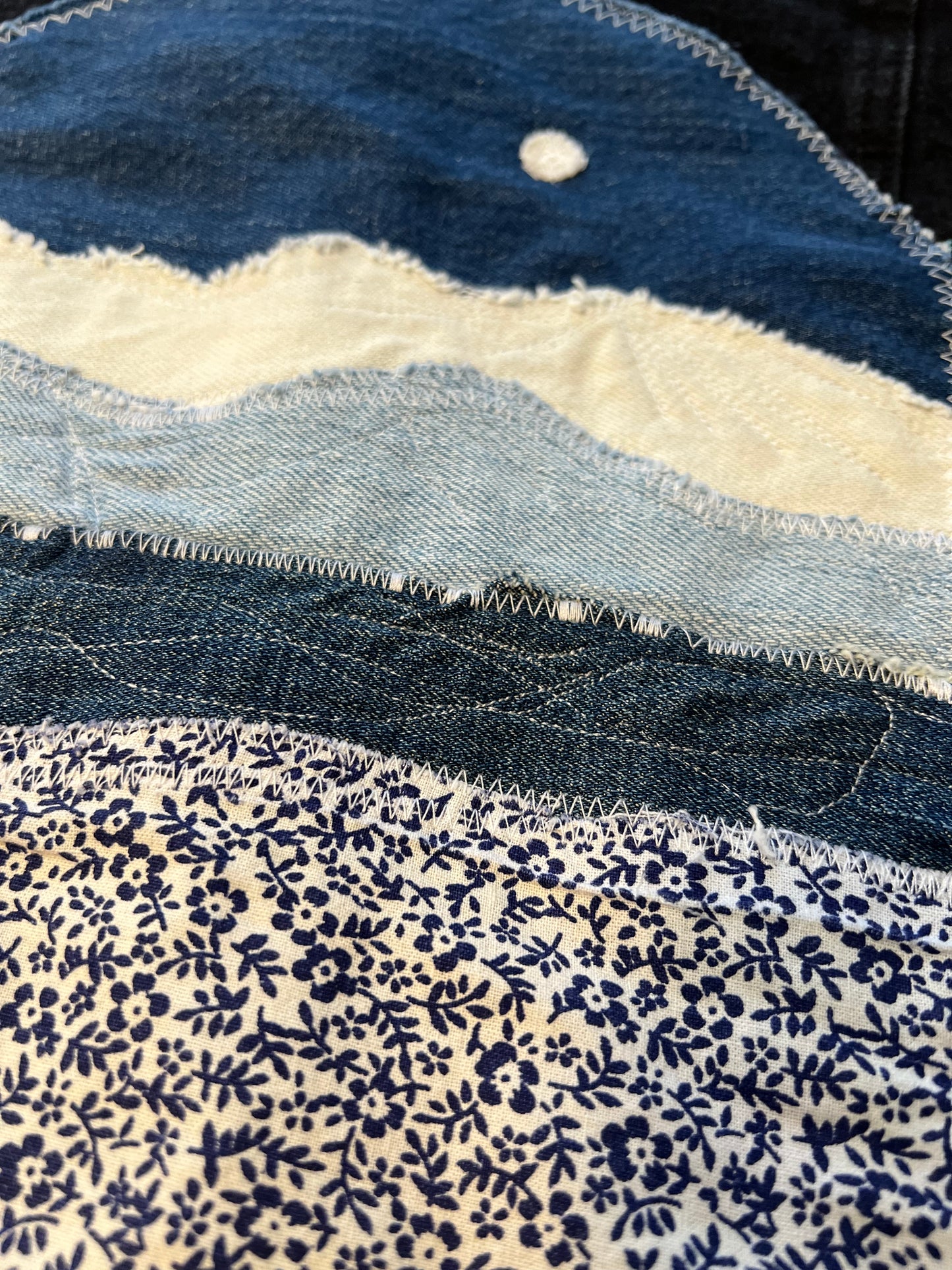 Black denim jacket with blue denim patch