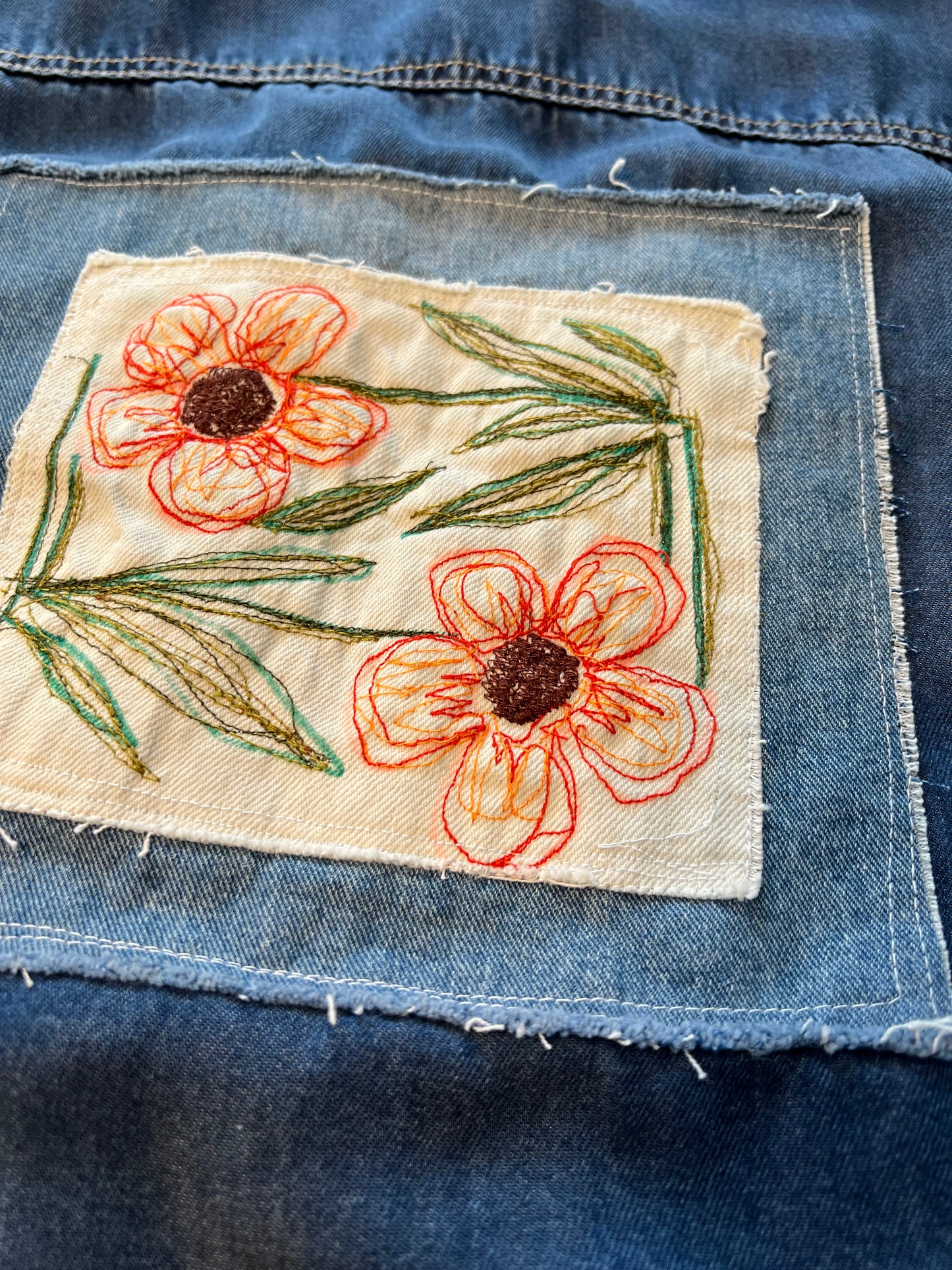 Soft light weight denim with embroidered floral patch