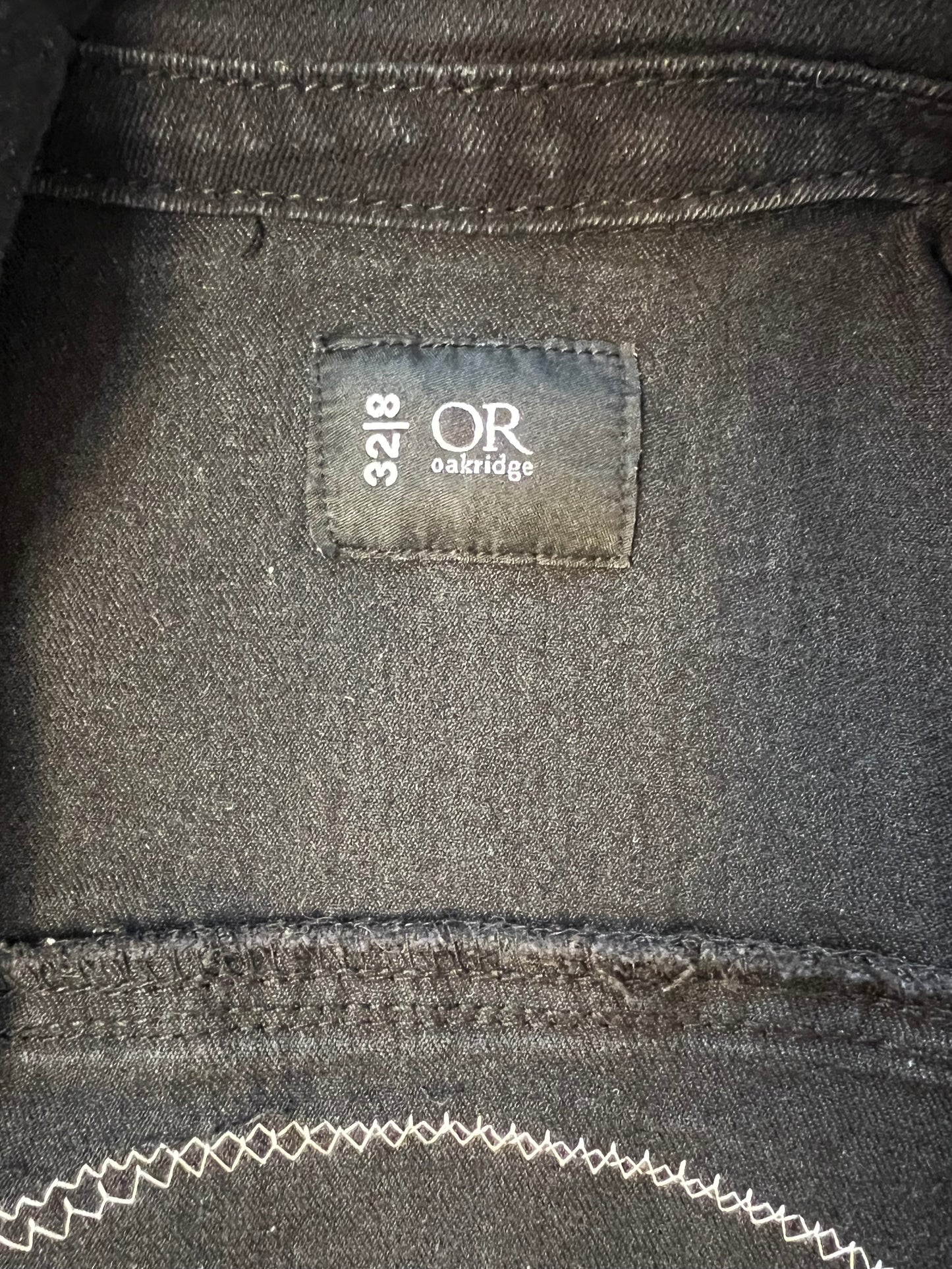 Black denim jacket with blue denim patch